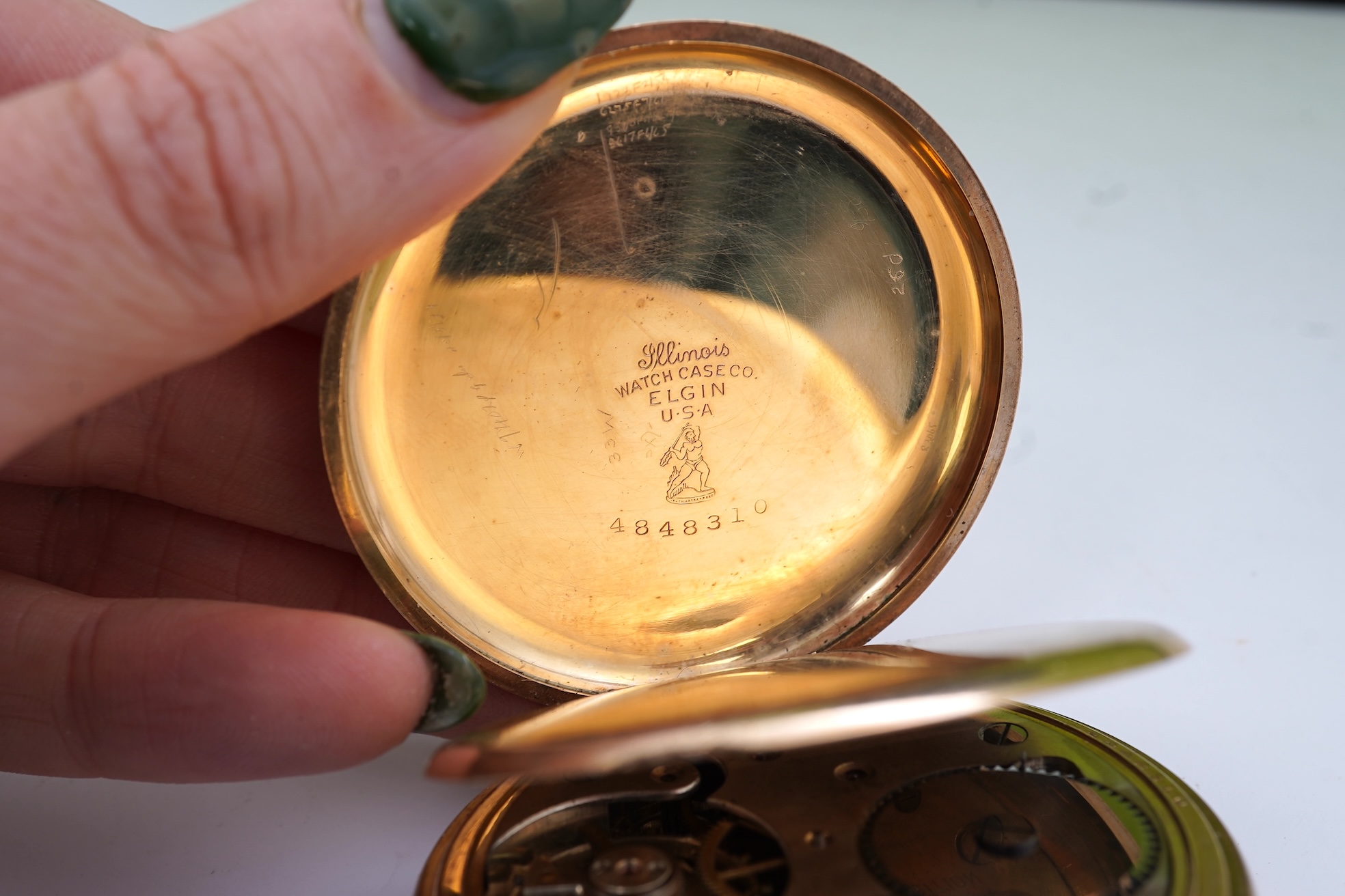An amethyst fob seal, a gold Albert chain, and a pocket watch